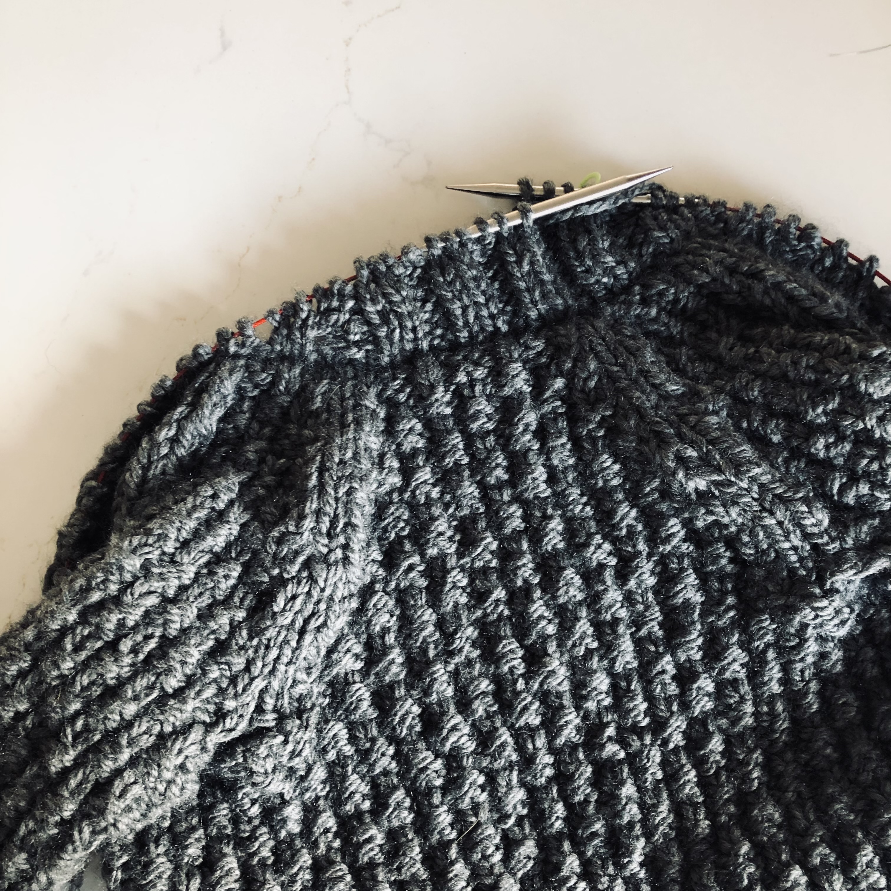 Grey handmade knitted Oxbow Cardigan work in progress still on the knitting needles