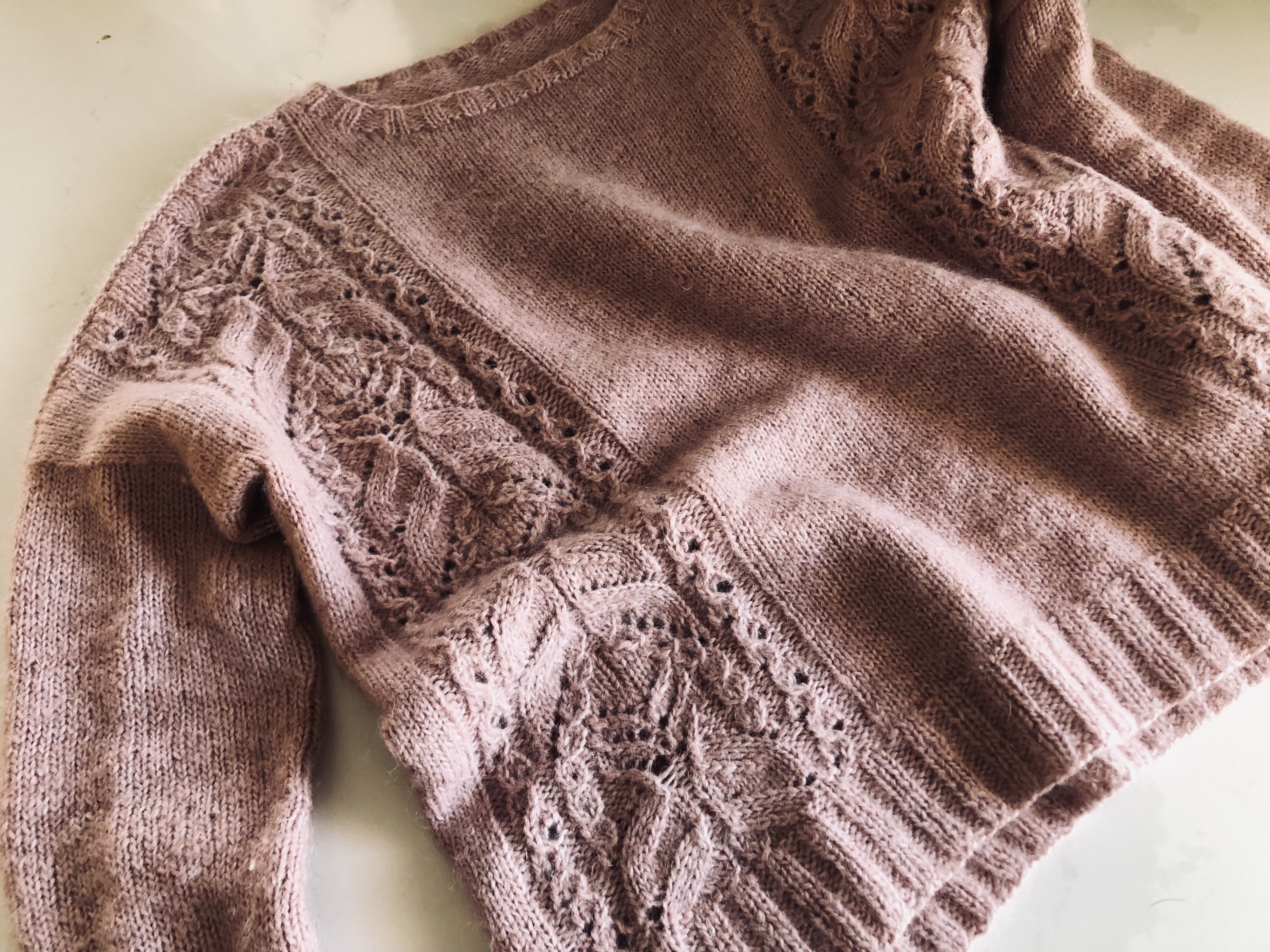 Handmade knitted pink sweater "Pink Fizz" has lace panels on the front and back with stockinette stitch.